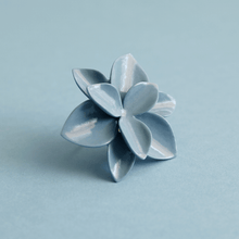 Load image into Gallery viewer, A blue porcelain ring, featuring a unique and captivating design, adding a pop of color to any outfit. Matching blue background.