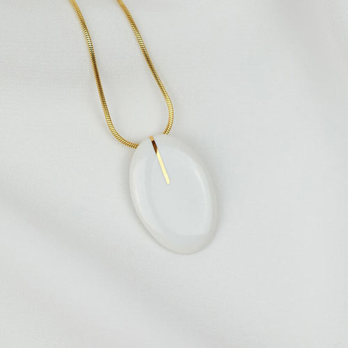 Porcelain pendant on a gold plated snake chain. Handmade jewel with minimal style. 