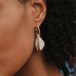 Close-up photo: light lavender ceramic earrings. Silver hoop.