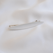 Load image into Gallery viewer, White porcelain hairpin. Delicate piece on a soft silk background. 