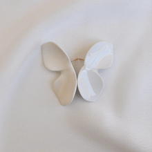 Load image into Gallery viewer, Product close-up: white porcelain earrings. Composition reminds a butterfly shape. White soft silk backgroun