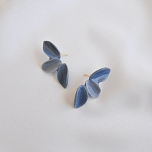 Load image into Gallery viewer, Three petals porcelain earrings. Timeless jewellery on a grey background.