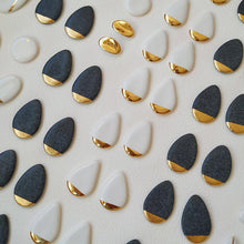 Load image into Gallery viewer, Kiln layer full with white and black earrings shapes. All of them with hand-painted gold details.