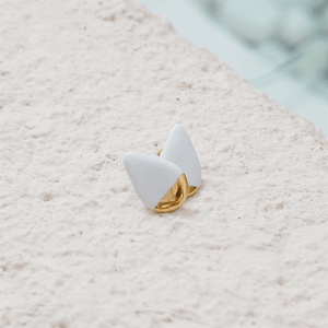 White and gold porcelain earrings. Bright photography.