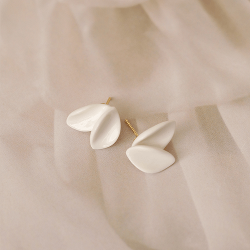 A pair of white porcelain earrings made of porcelain, featuring a unique and captivating design.