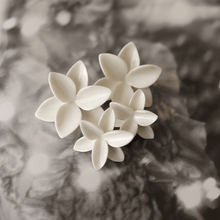 Load image into Gallery viewer, Similar in design, different size. Four porcelain flower earrings together, mimicking a bouquet. Black and white diffused background.