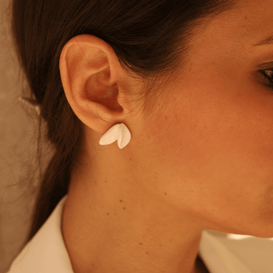 Bride wearing stunning minimal porcelain earrings for effortless chic. Traditional Portuguese ceramics jewellery with a contemporary approach. Porcelain earrings with two petals. 