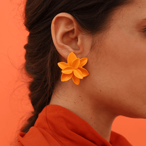 A vibrant strong orange porcelain flower earring, showcasing its intricate design and elegant craftsmanship.