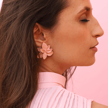 Load image into Gallery viewer, A stylish woman with her eyes closed wearing a soft pink blouse and showcasing a pair of delicate soft pink porcelain earrings against a matching soft pink backdrop.