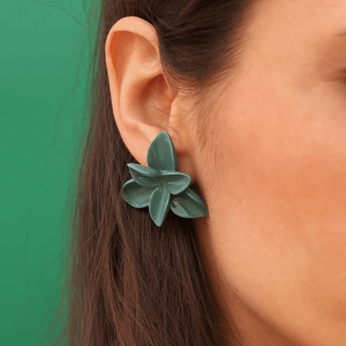 Nature-inspired jewellery: woman wearing a timeless accessory. Green porcelain flower earrings.art. Green photshoot. 