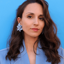 Load image into Gallery viewer, A stylish woman wearing a blue coat and showcasing a pair of blue porcelain earrings against a matching blue backdrop.