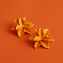 Load image into Gallery viewer, A pair of porcelain earrings. Strong orange accessories on an orange background. Dreamy porcelain garden. 