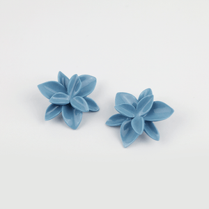 A pair of elegant blue porcelain flower earrings, featuring intricate petal details and a delicate design.
