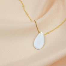 Load image into Gallery viewer, White porcelain pendant on an elegant gold chain. 24k gold luster detail. 