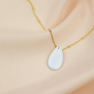 White porcelain pendant on an elegant gold chain. 24k gold luster detail. 