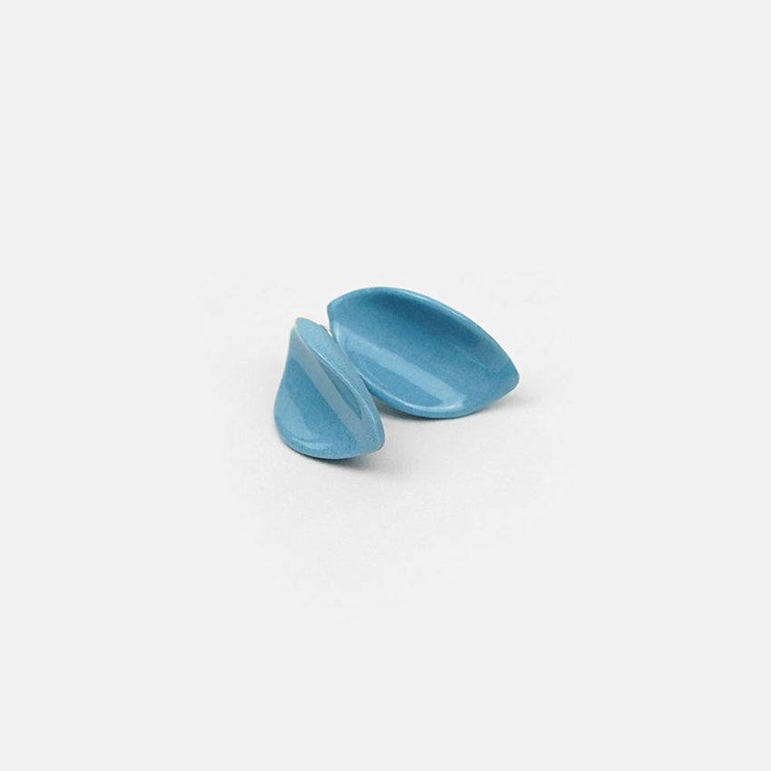 Inspired by petals delicacy: blue porcelain earrings handmade. Gloss glaze finishing. Bright background. Product close-up.