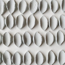 Load image into Gallery viewer, At the studio: raw porcelain petal-shaped pieces drying for days, before being polished.