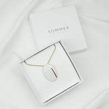 Load image into Gallery viewer, White packaging with gold typographic logo printed with foil technique. Product photography.
