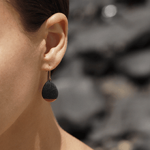 Load image into Gallery viewer, Black porcelain jewels. Close-up on a contemporary ceramic earrings. 