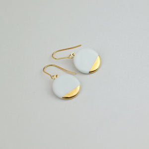 Round white porcelain earrings. Bright product photography. 