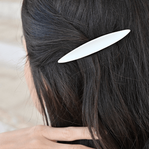 Brunette model wearing a minimal white porcelain hairpin. 