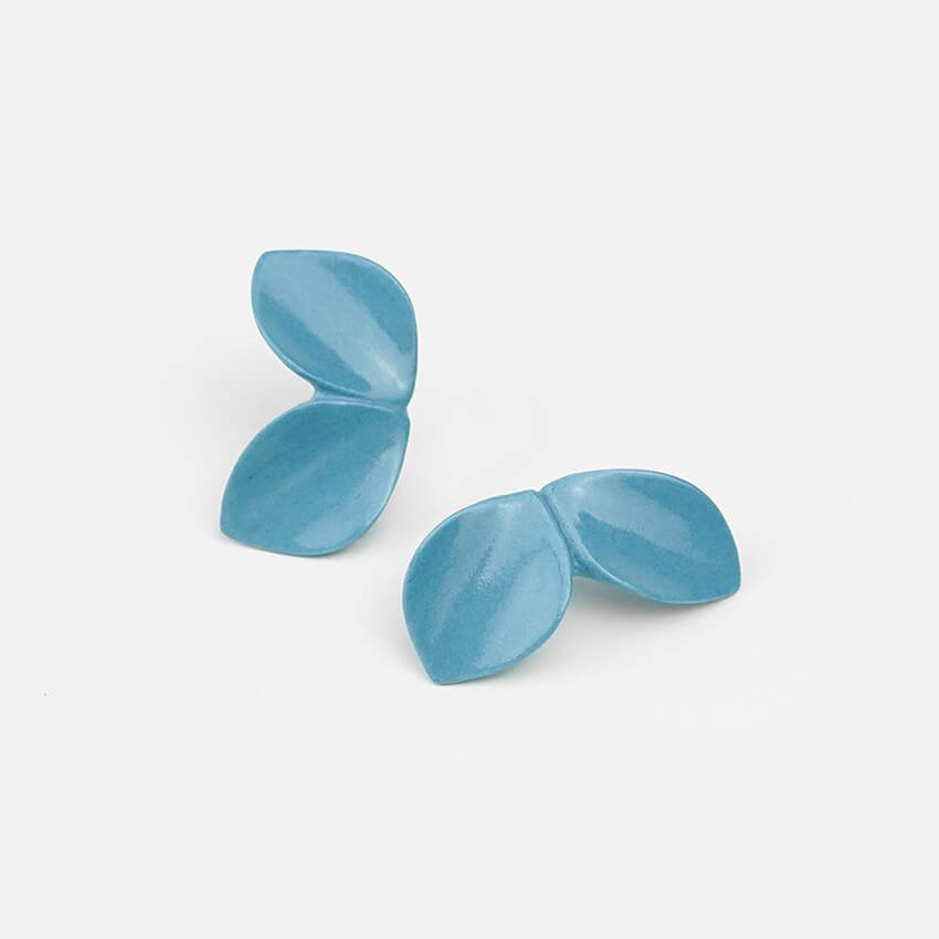 Ceramic clay earrings: light blue earrings on a bright background. 
