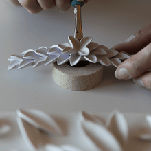 Load image into Gallery viewer, Work of art: artisan hand painting all the petals. Raw ceramic floral design will turn into a beautiful and delicate headpiece. 