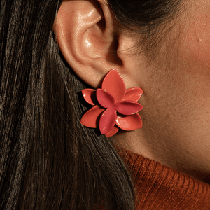 A vibrant red porcelain flower earring, showcasing its intricate design and elegant craftsmanship.