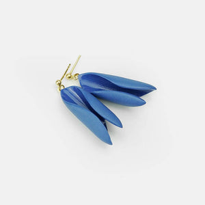 Dangle earrings with minimal style. Blue porcelain earrings. Light grey background. 