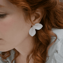 Load image into Gallery viewer, Floral design earring. Red-haired model with a delicate white earring. Nature-inspired jewels. 