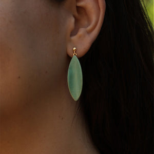 Close-up photography: olive green porcelain earrings.